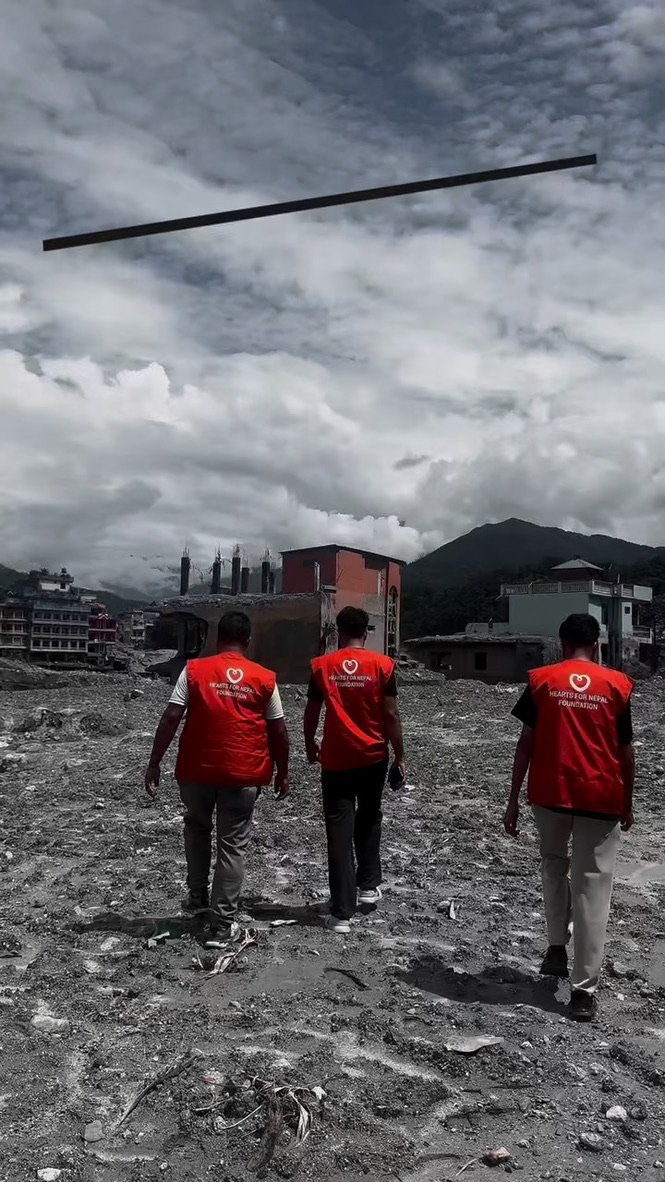 Three Hearts for Nepal staff walking through debris left by the flood